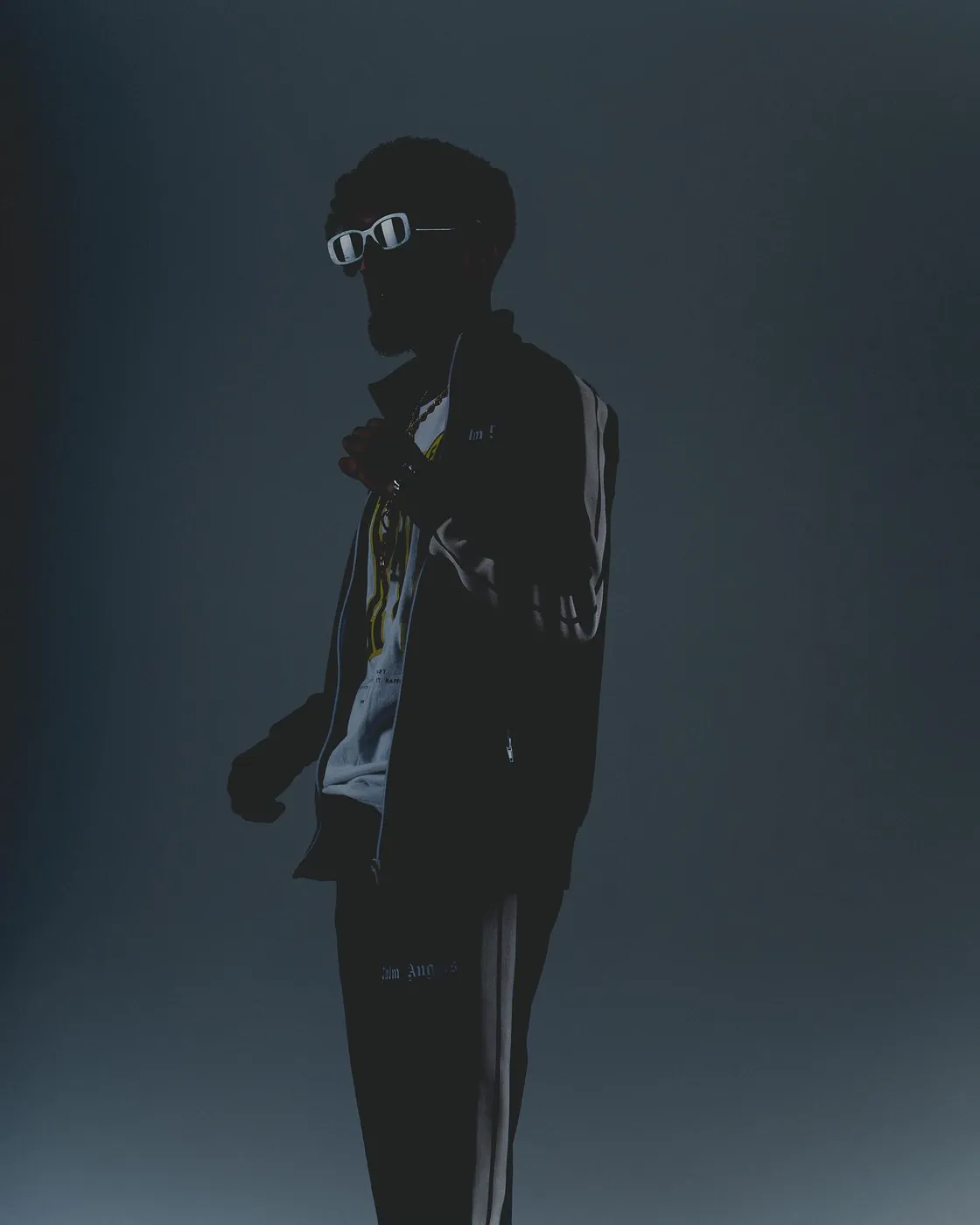 In sunglasses, in blue-grey light
