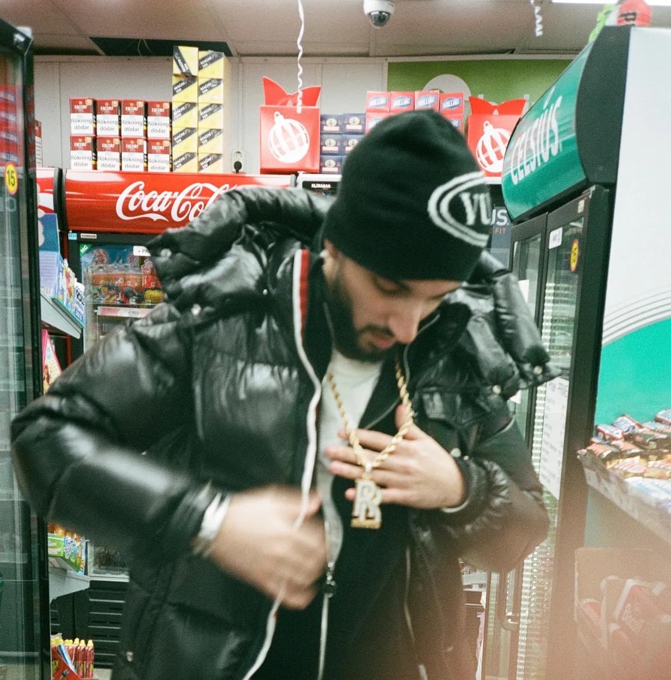 In a beanie, in a corner shop