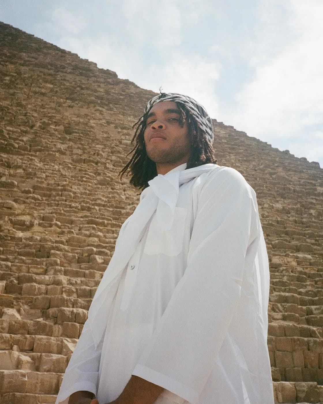 In white in front of a pyramid